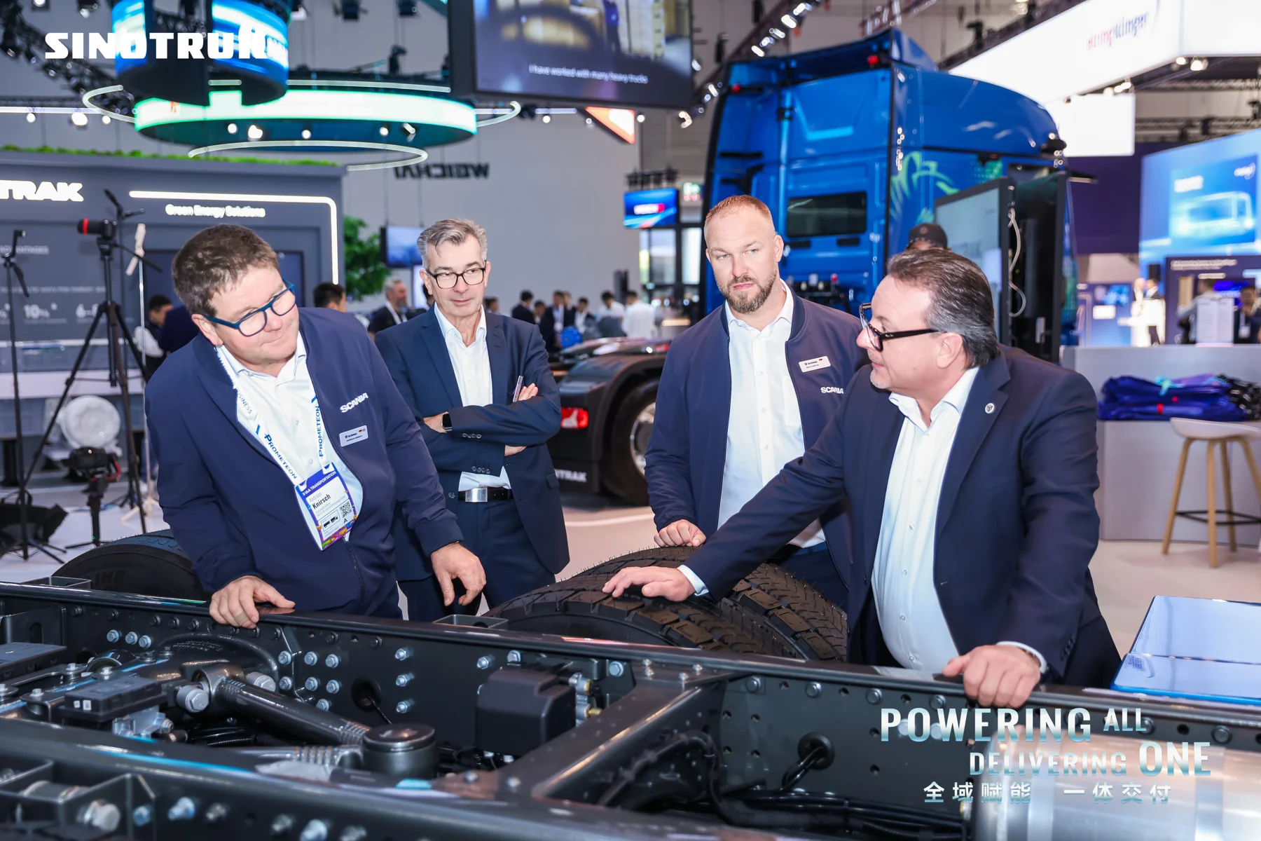 Visitors discussing SINOTRUK vehicle technology