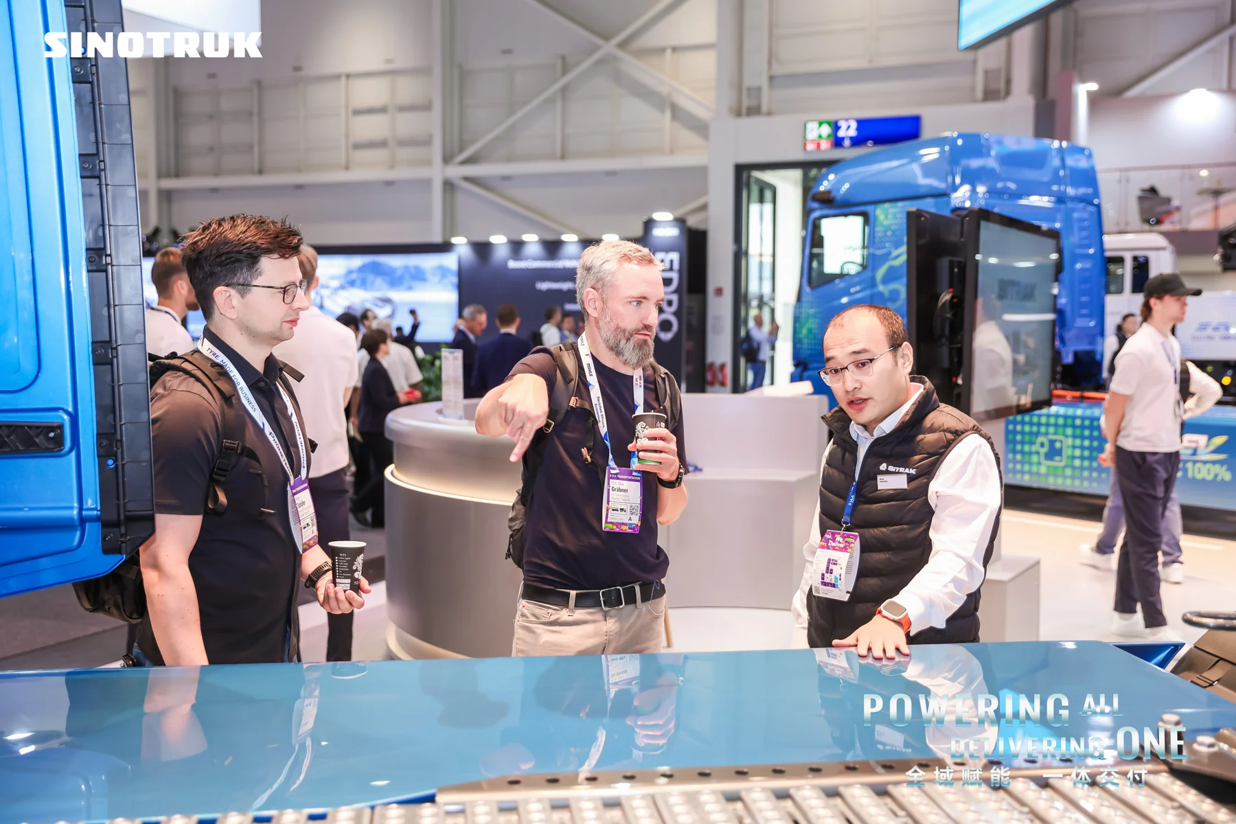SINOTRUK representatives speaking with exhibition visitors