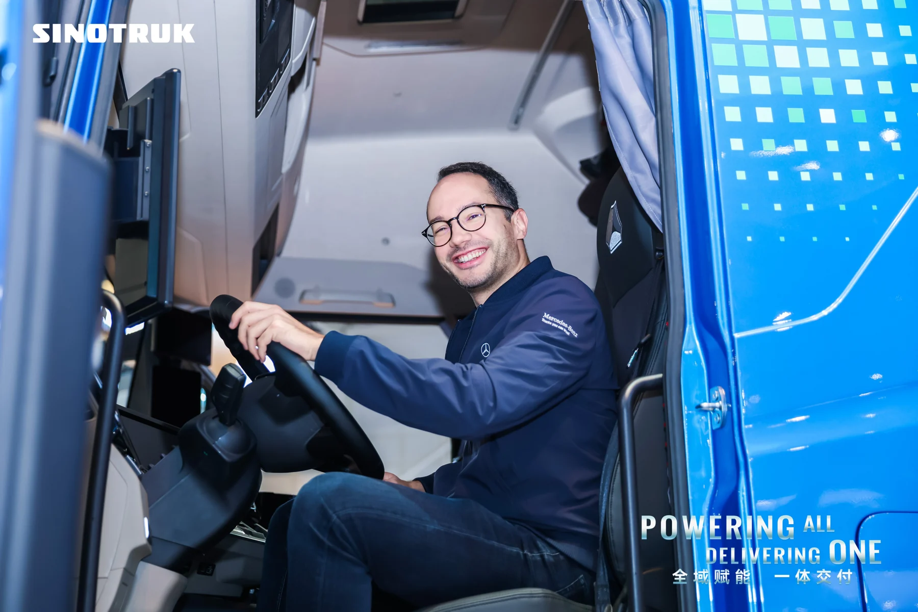 Visitor exploring a SITRAK truck cab