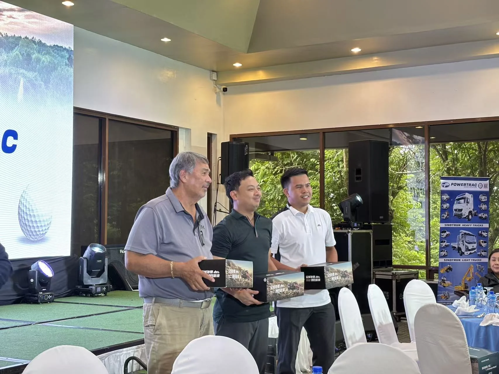 Powertrac Cup participants holding miniature truck prizes